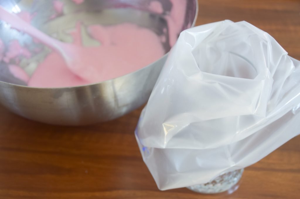 Putting the pink macaron batter into the piping bag