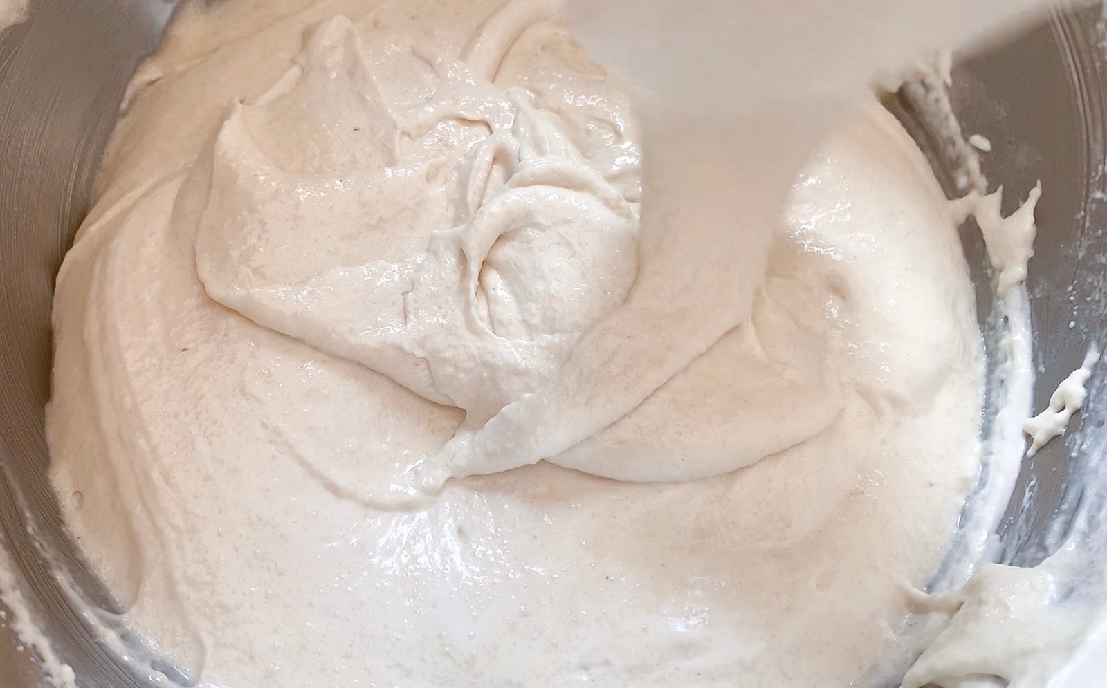 Folding white macaron batter during macaronage
