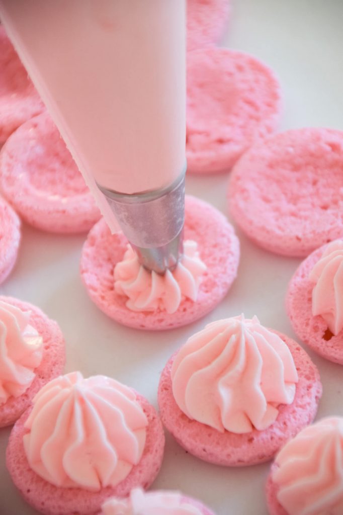 Filling the light pink macarons ruffle style