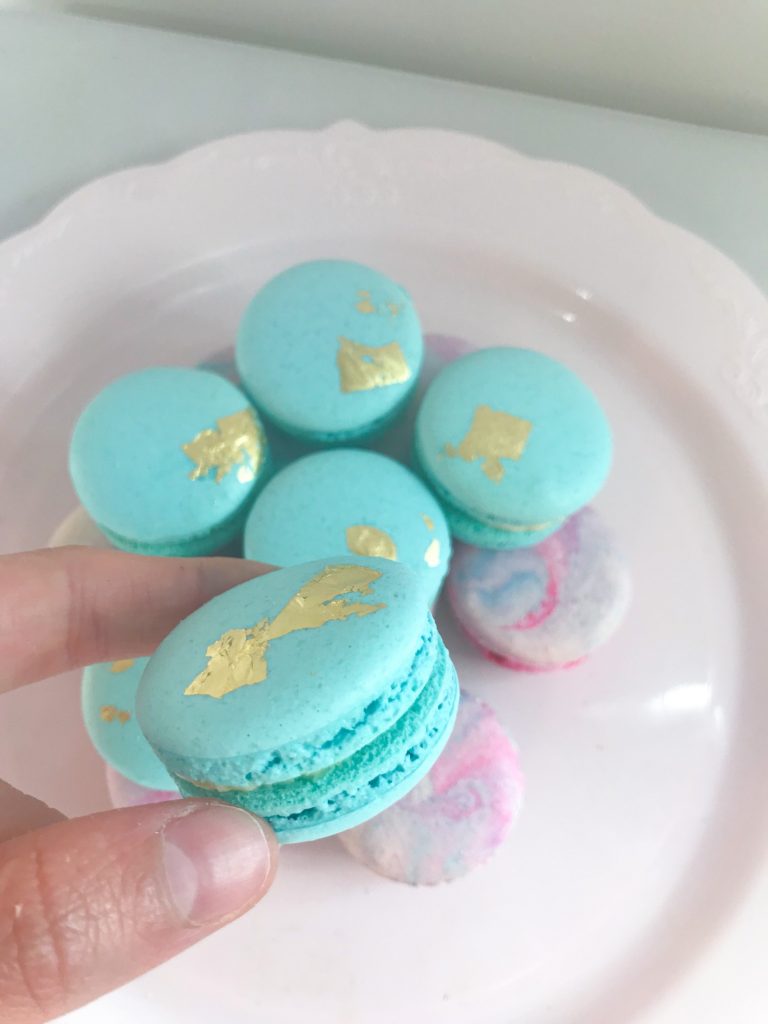 Blue macarons with edible golf leaf