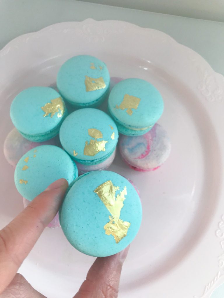 Blue macarons with edible golf leaf