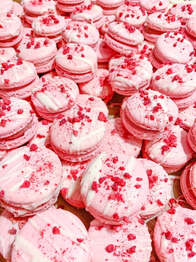 Pink macarons with white chocolate and cold dried fruit raspberries