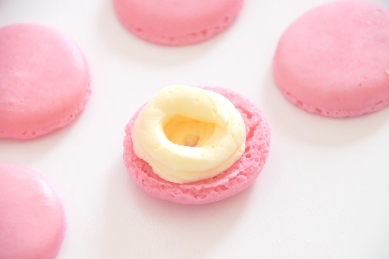 Piping a buttercream ring for a raspberry center