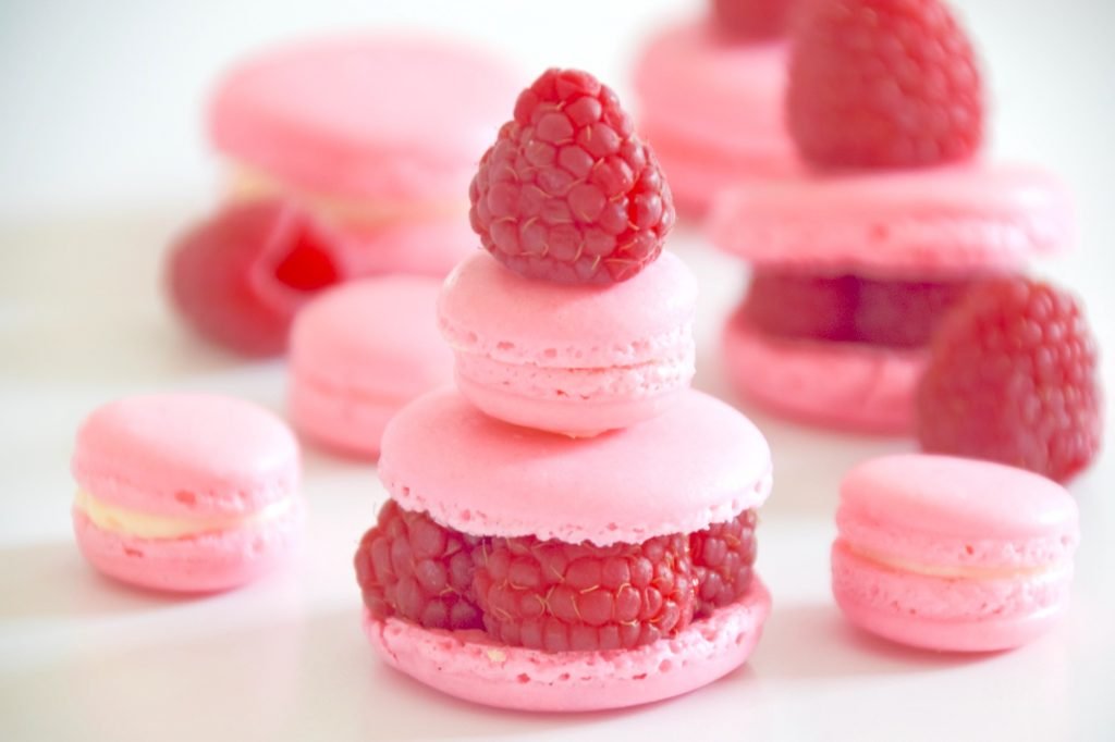 Pink macarons with fresh raspberries