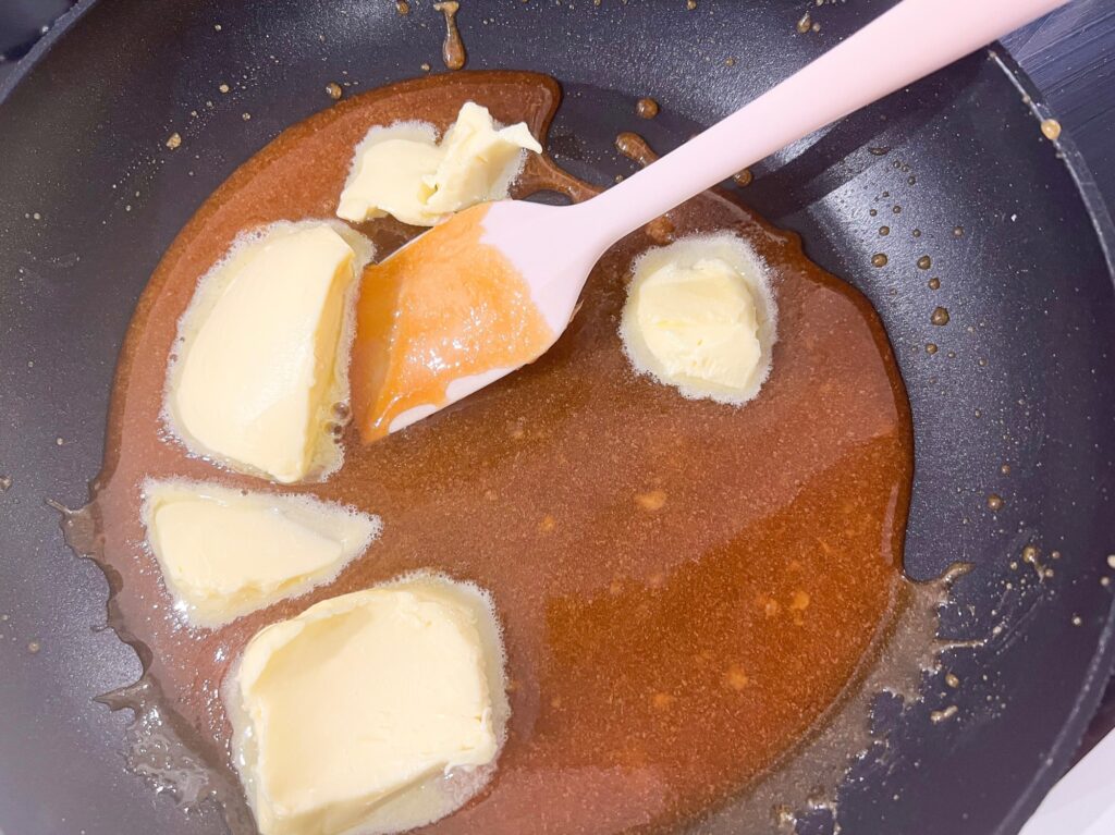 Homemade salted caramel sauce cooking on a pan with butter