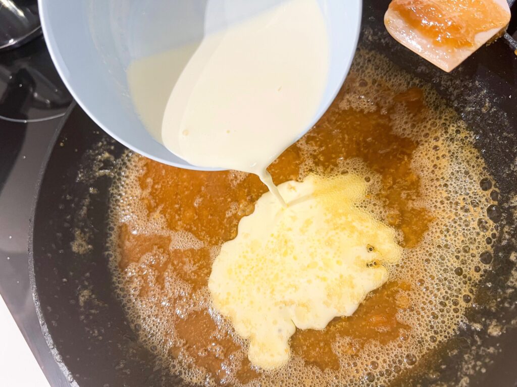 Homemade salted caramel sauce cooking on a pan with butter