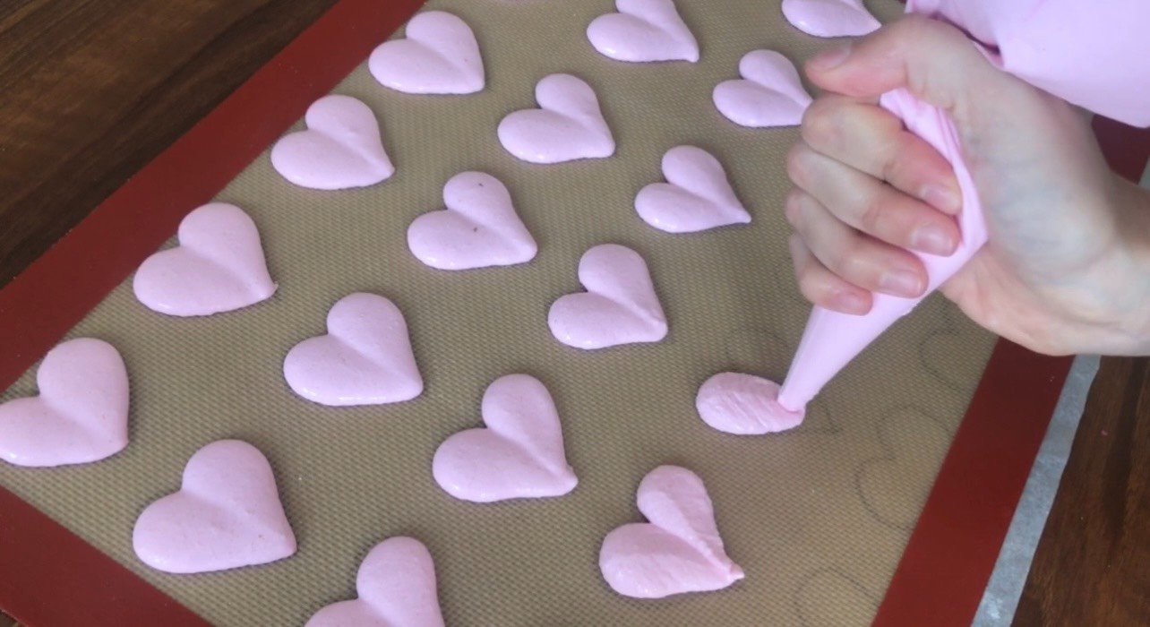 Repeating heart outlines on a macaron template