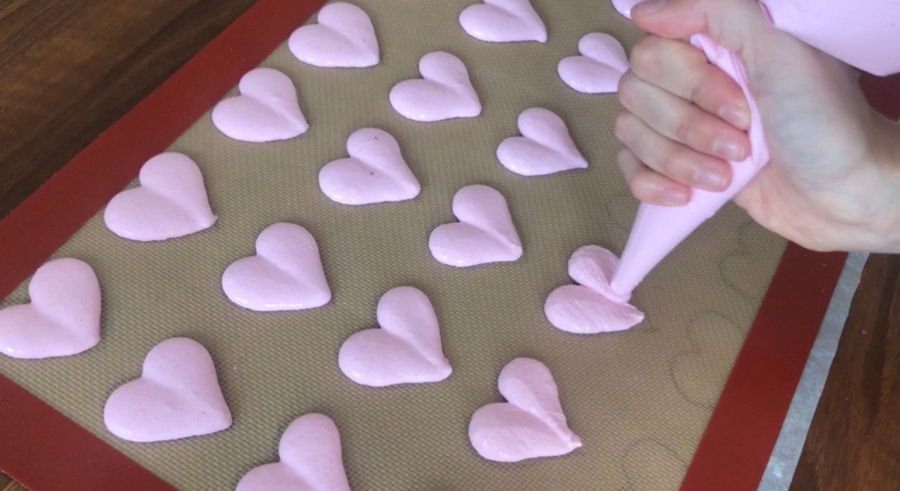 Completed heart macaron template beneath a liner