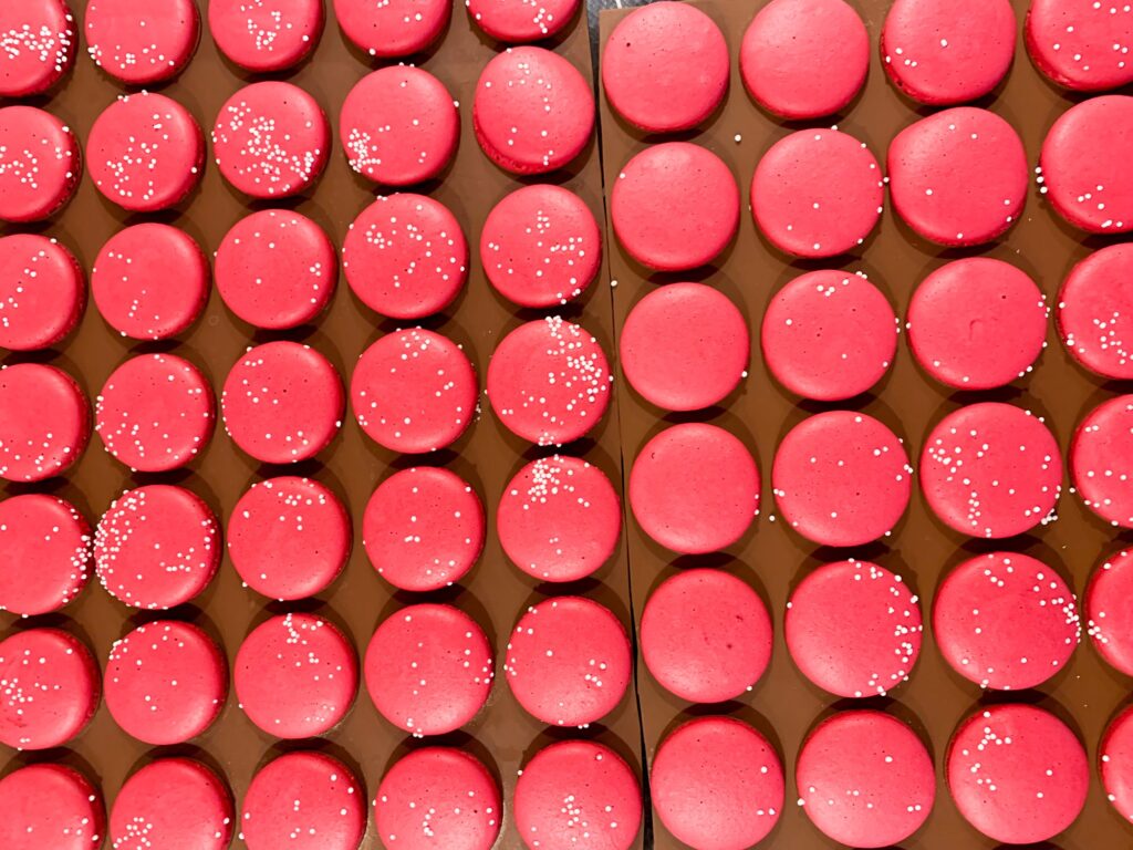 Red macarons with sprinkles on top