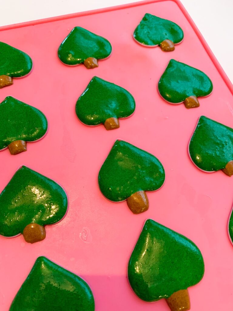Green Christmas tree macarons on a silicone mat