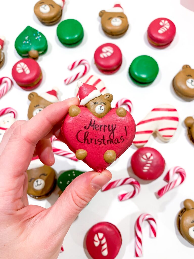 Christmas themed heart-shaped macarons with candy cane shaped macarons