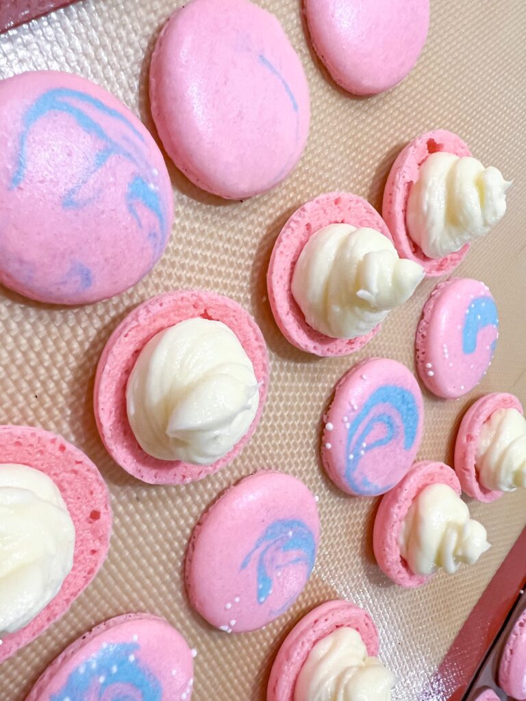 Pink multicolored bubblegum macaron shells with sprinkles and filling